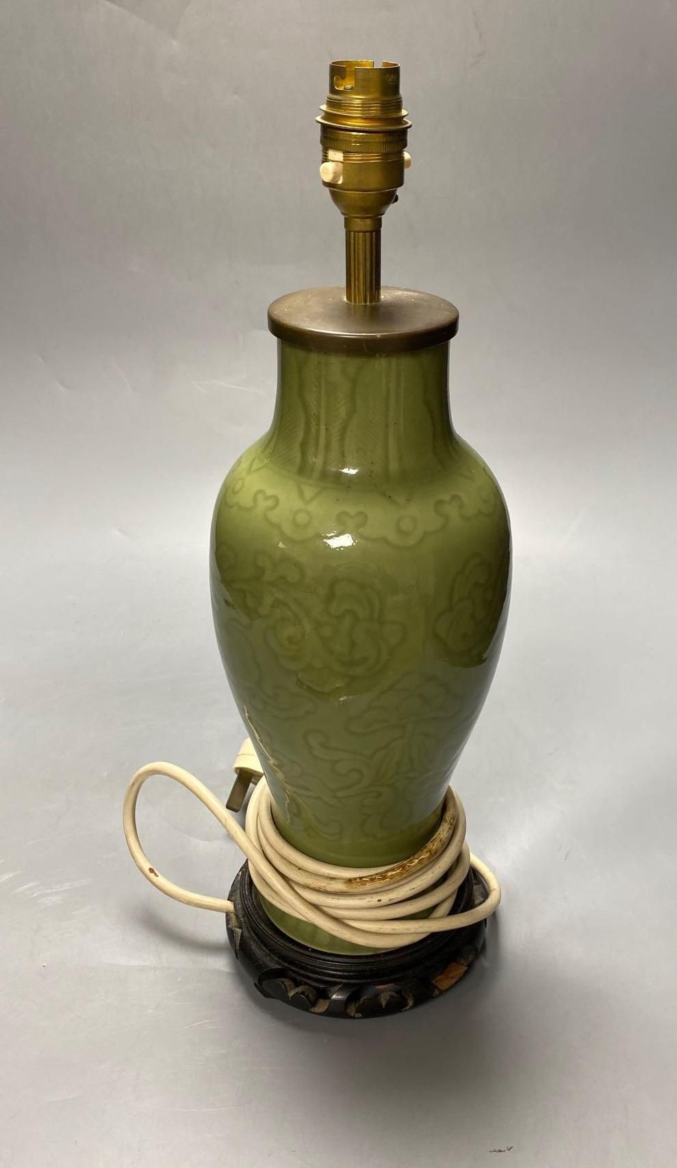 A Chinese green celadon baluster vase, adapted as a table lamp, total height excluding the top fitting 32cm